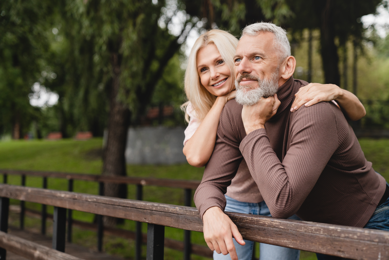 couple standing on bridge outside together